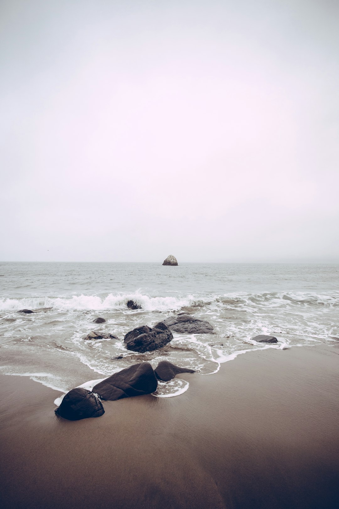 rocks on sea side at daytime