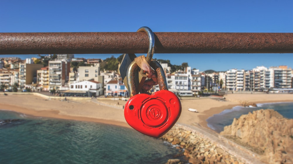 heart padlock hanging on brown pipe