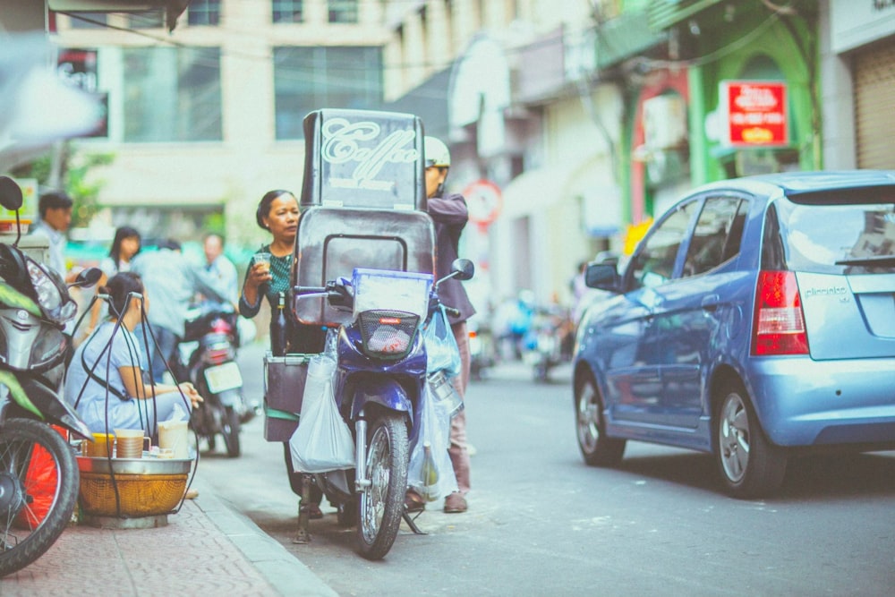 parked blue underbone motorcycle near road gutter