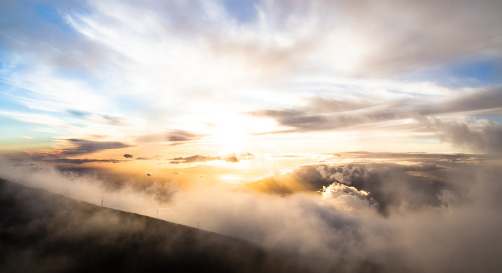 clouds above mountains during golden hour