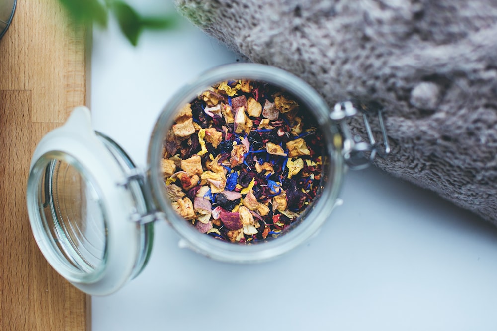 selective focus photography of petals inside glass jar