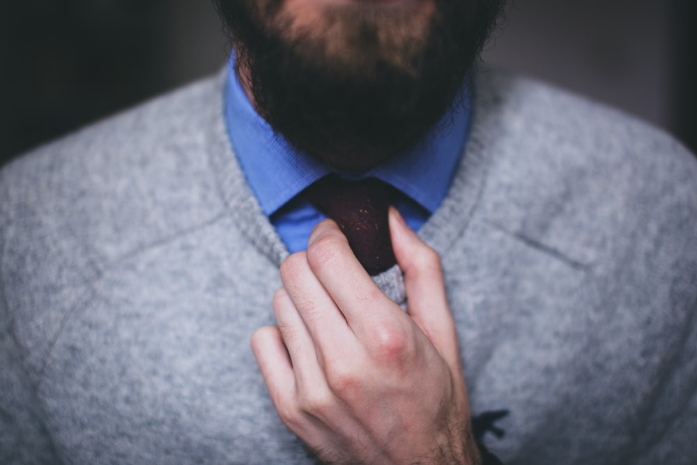 man wearing gray sweater