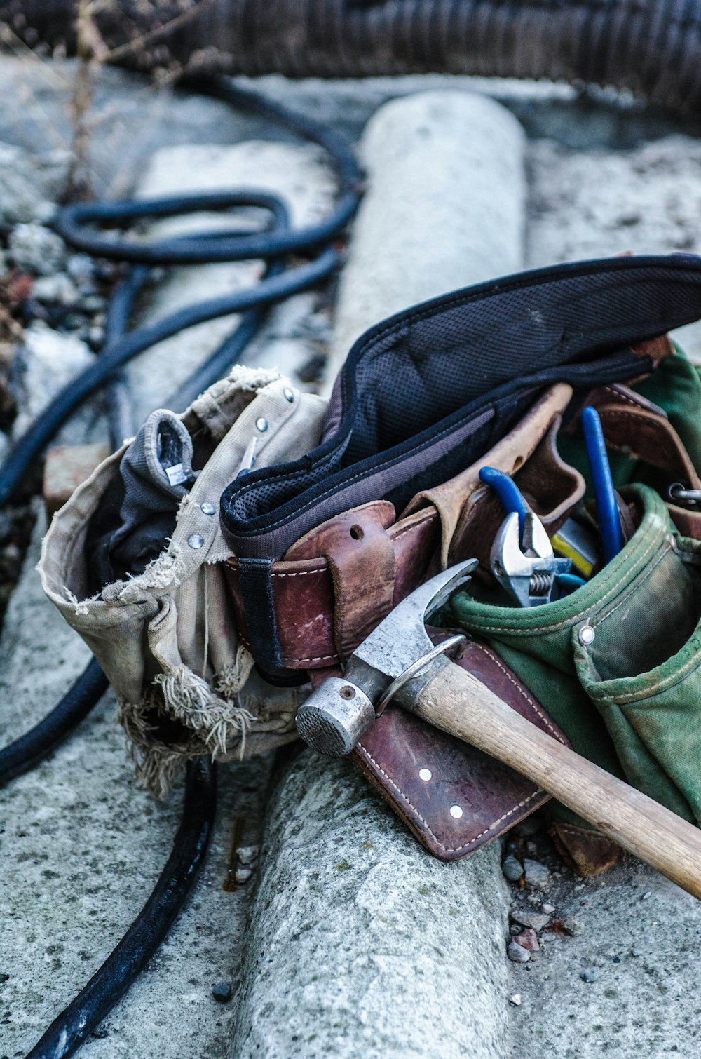 A hammer on a leather toolbelt