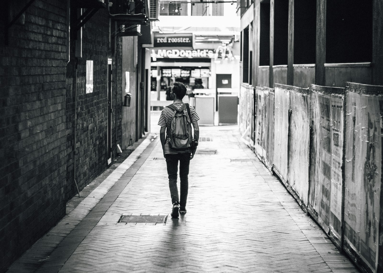 Canon EOS 70D + Canon EF 50mm F1.8 II sample photo. Man walking between concrete photography