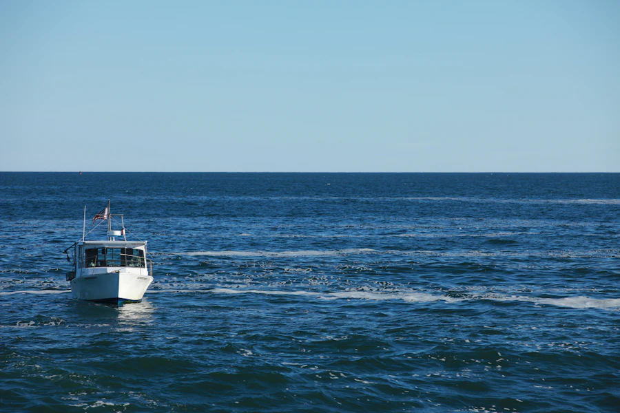 A fishing boat running across open blue water