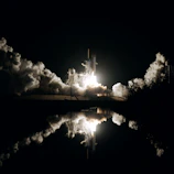 Artemis II astronauts preparing for launch against a starry black sky.