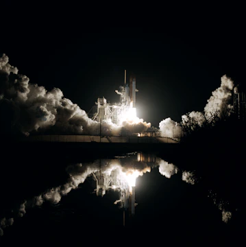Artemis II astronauts preparing for launch against a starry black sky.