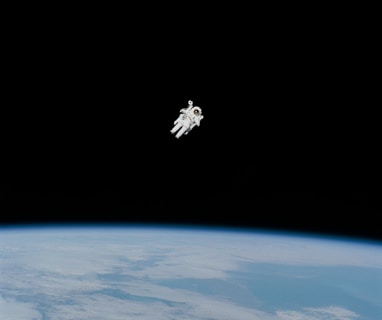 astronaut in spacesuit floating in space