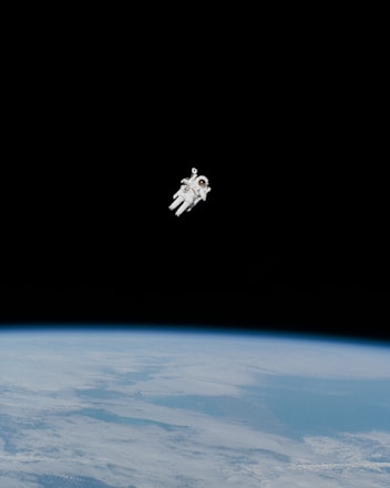 astronaut in spacesuit floating in space