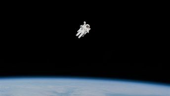 astronaut in spacesuit floating in space