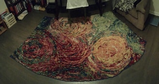 A vibrant, custom-designed rug laid out in a cozy living room setting.