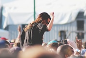 woman on top of crowd