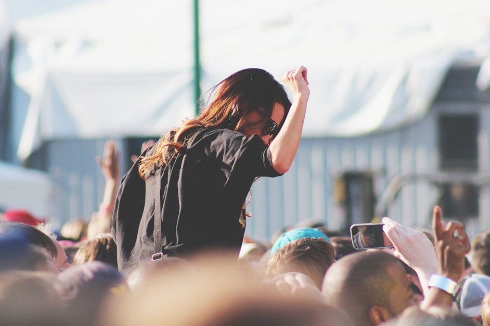 woman on top of crowd