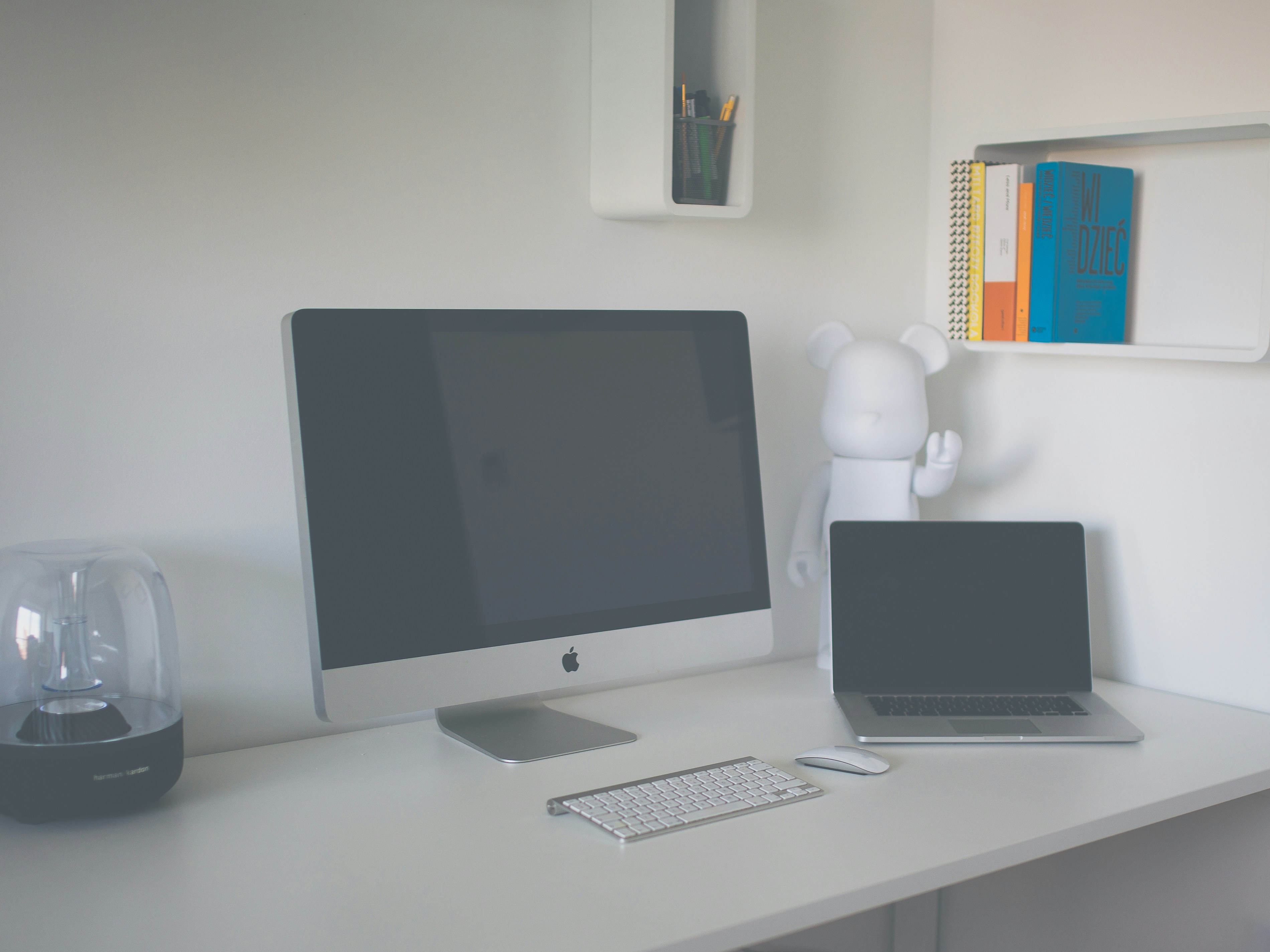 Modern workspace with multiple devices running AI tools, including a laptop, smartphone, and desktop monitor. Bright lighting, minimalist and professional atmosphere.