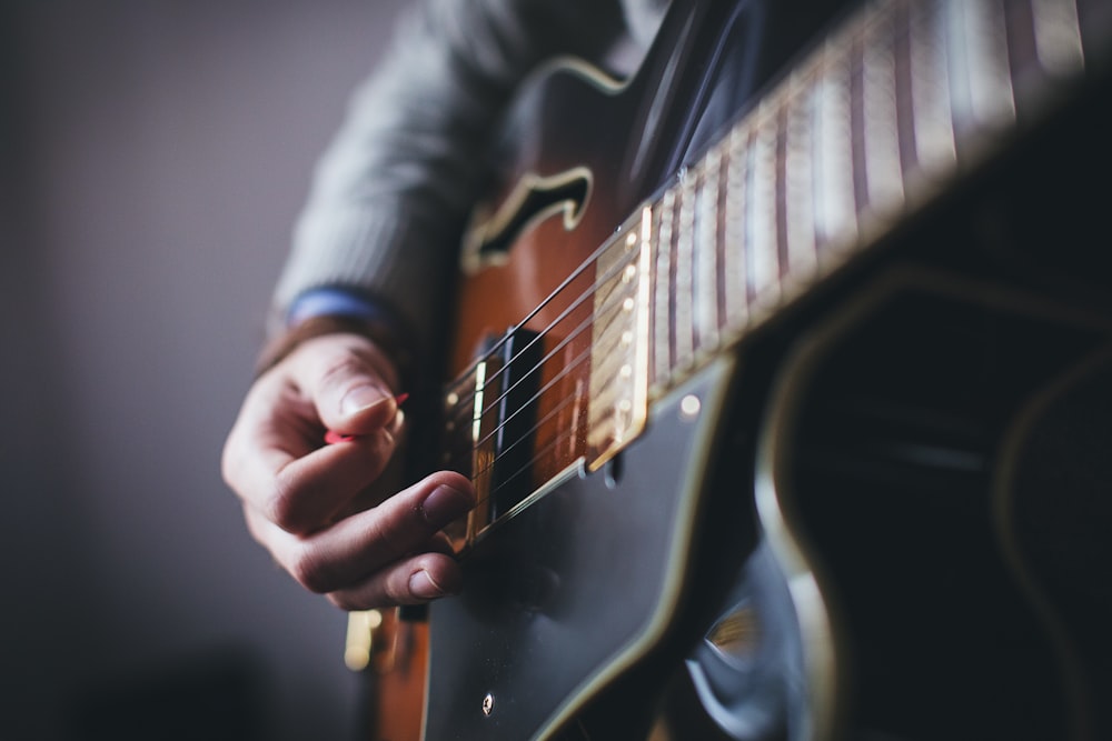 person playing guitar - 5 practice habits for musicians