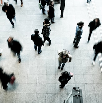 people walking on grey concrete floor during daytime