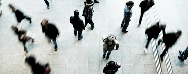 people walking on grey concrete floor during daytime