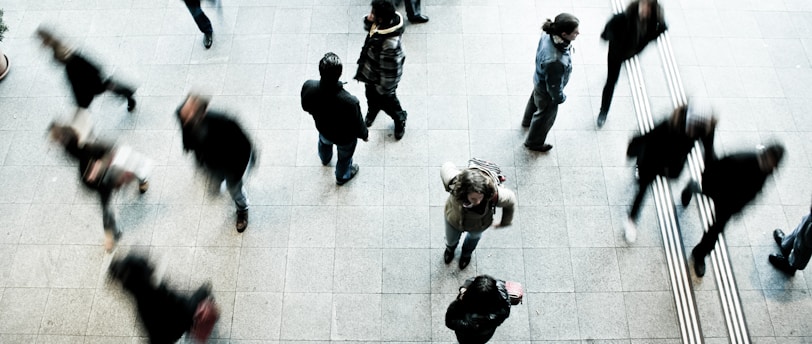 people walking on grey concrete floor during daytime