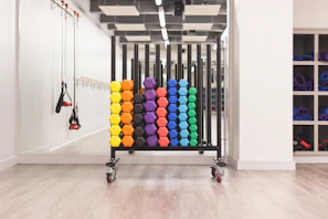 A colorful assortment of fitness equipment like yoga mats, dumbbells, and resistance bands.