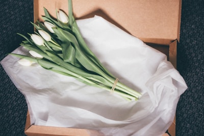 A luxury gift bouquet with vibrant tulips and delicate baby's breath in a chic box.