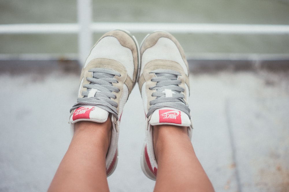 person wearing brown-and-white Nike sneakers