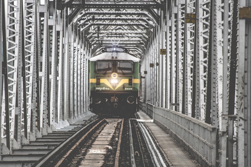 green train on railroad