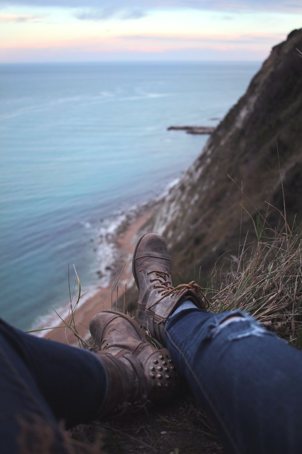 person sitting on mountain cliff