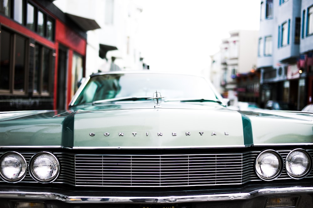 green Continental car during daytime