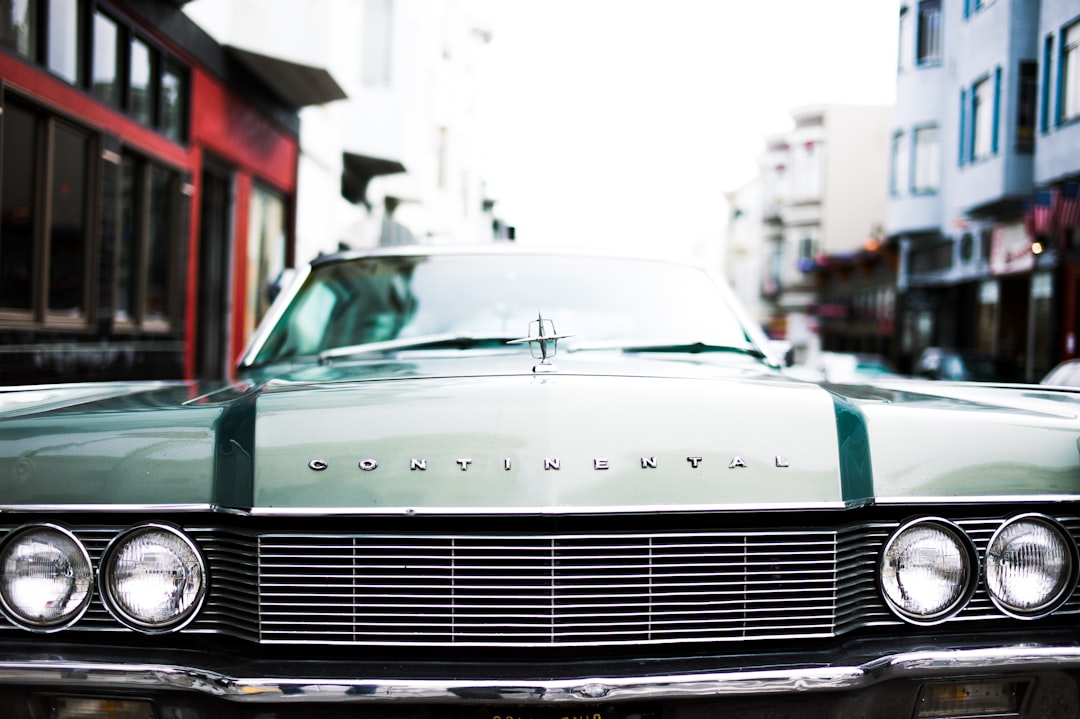 green Continental car during daytime