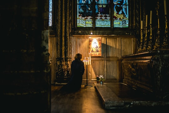 person praying in front of an altar in Saint-Séverin France