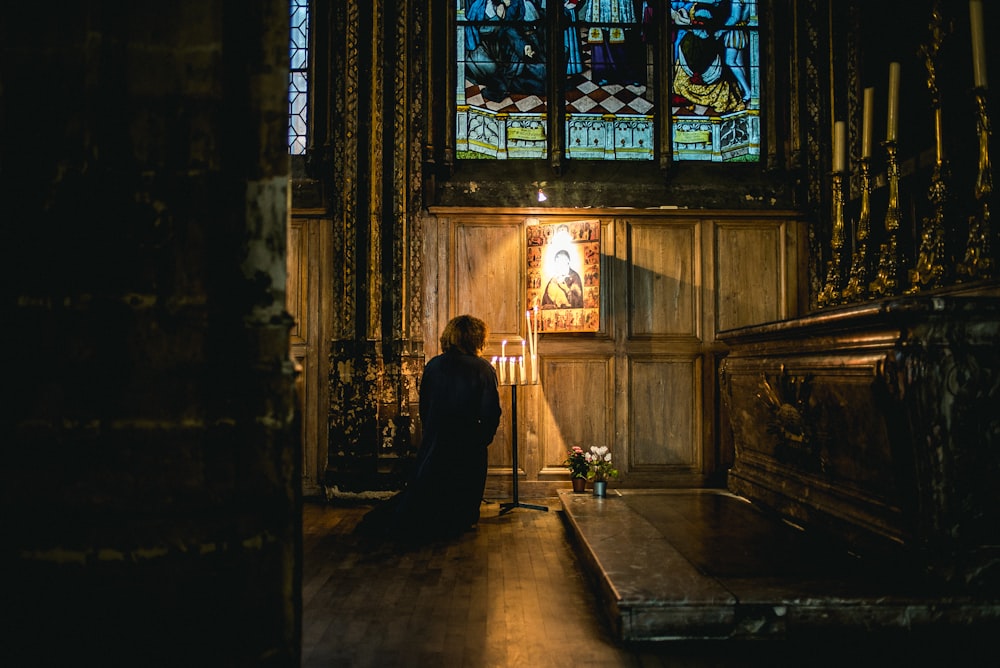 person praying in front of an altar