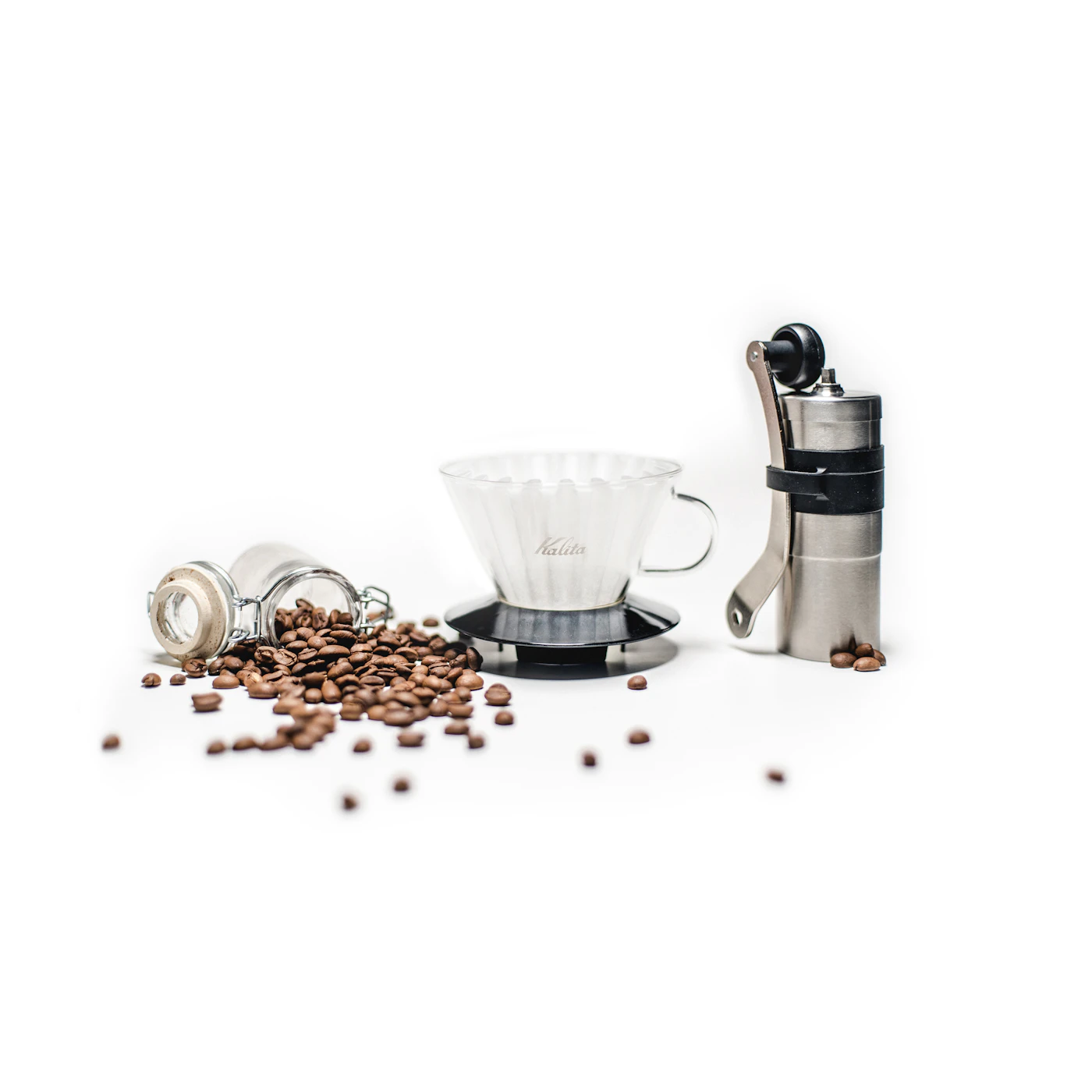 A hand grinder, a glass dripper and freshly roasted beans