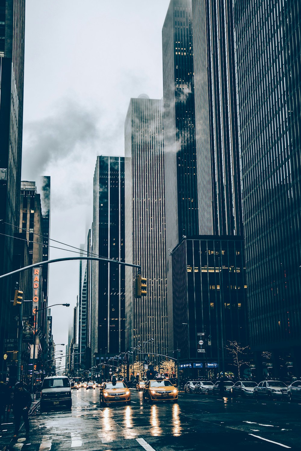 two yellow cars besides concrete buildings