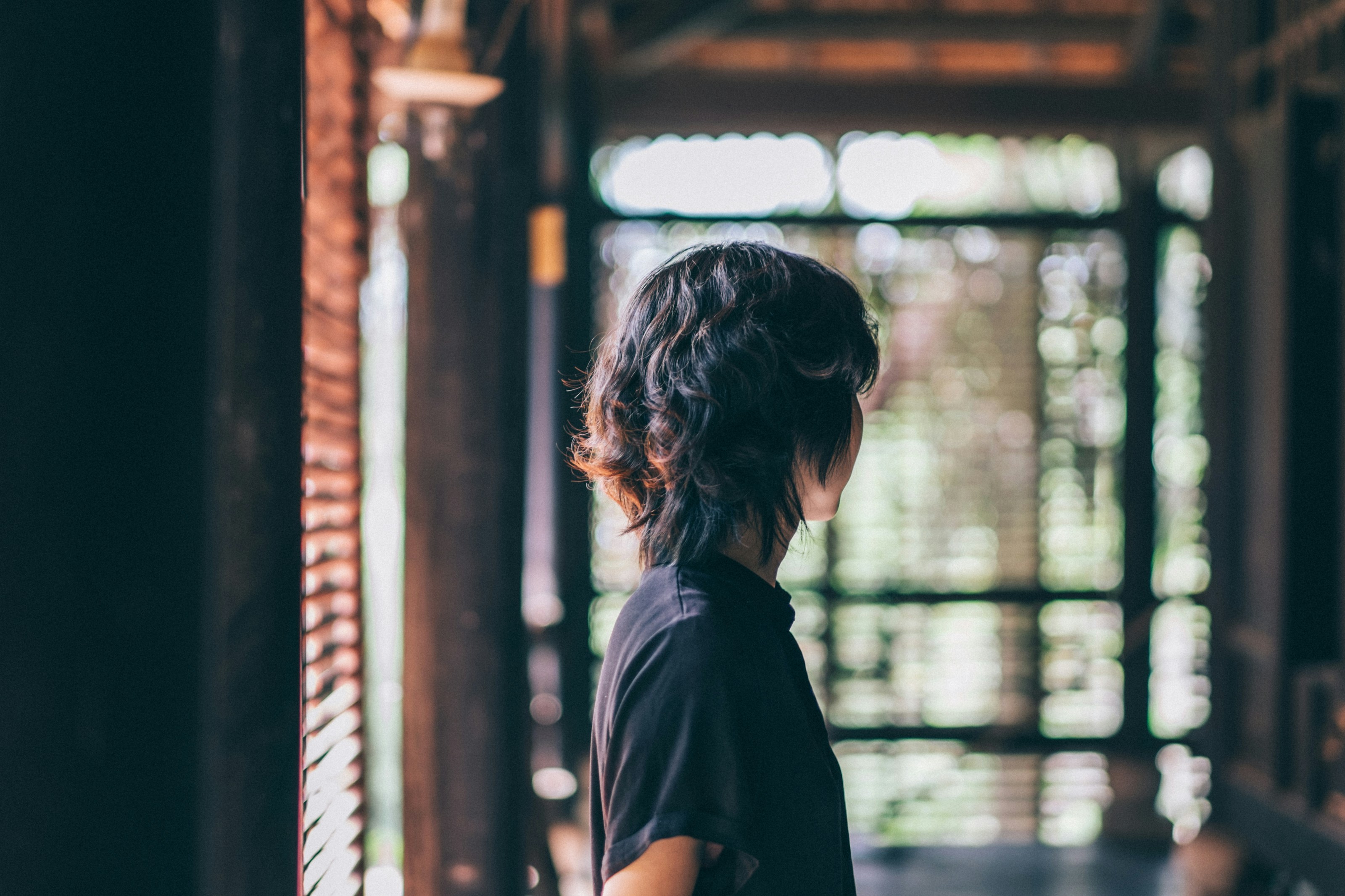 Woman looking out blinds