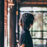 man wearing black shirt entering a room