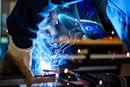 man holding gray steel frame