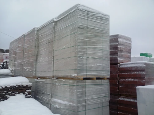 Heavy-duty plastic sheeting wrapped around pallets for secure shipping.