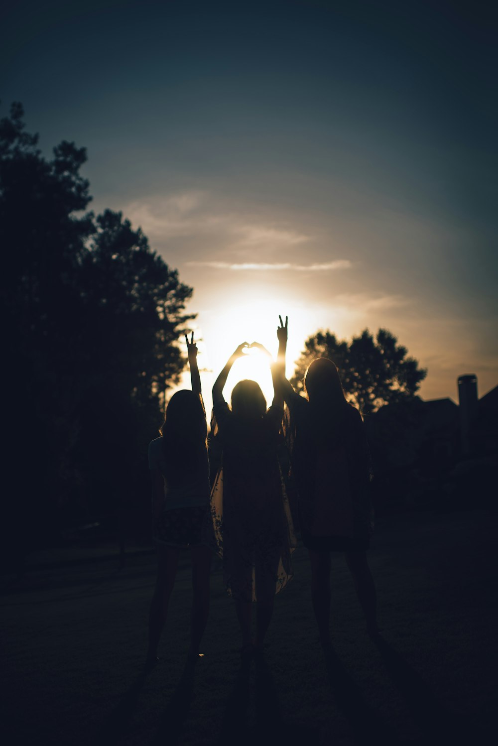 silhouette of three women during daytime