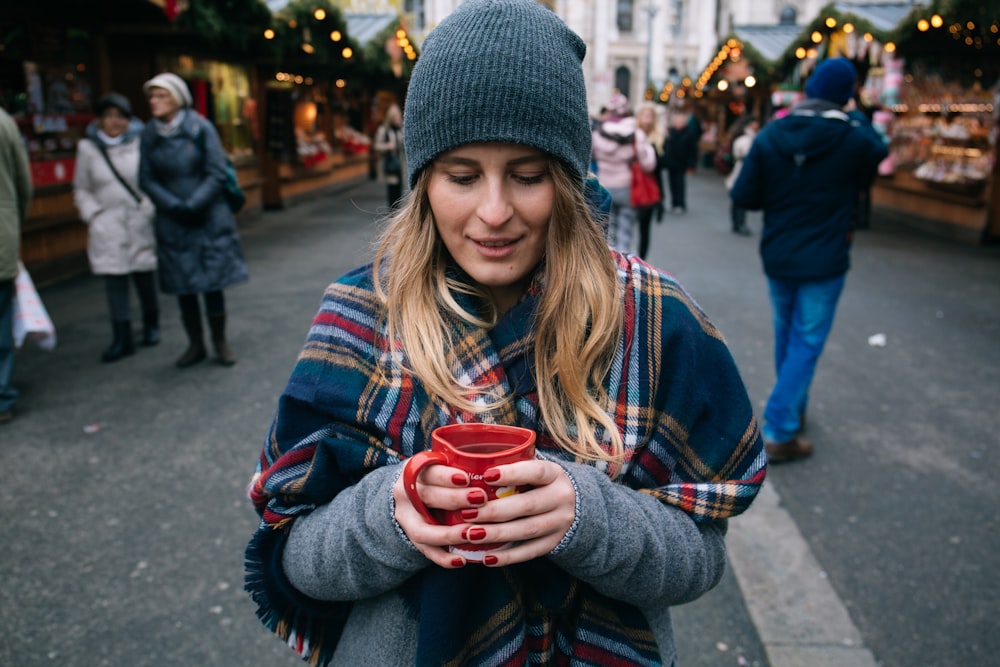 woman holding cup of coffee