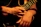 Close-up of a guitar player’s hands skillfully strumming chords on a vintage electric guitar.