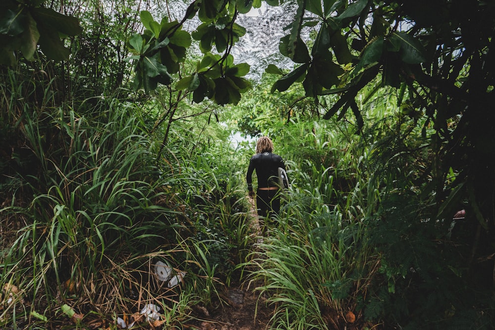 woman walking on animal trail during daytime