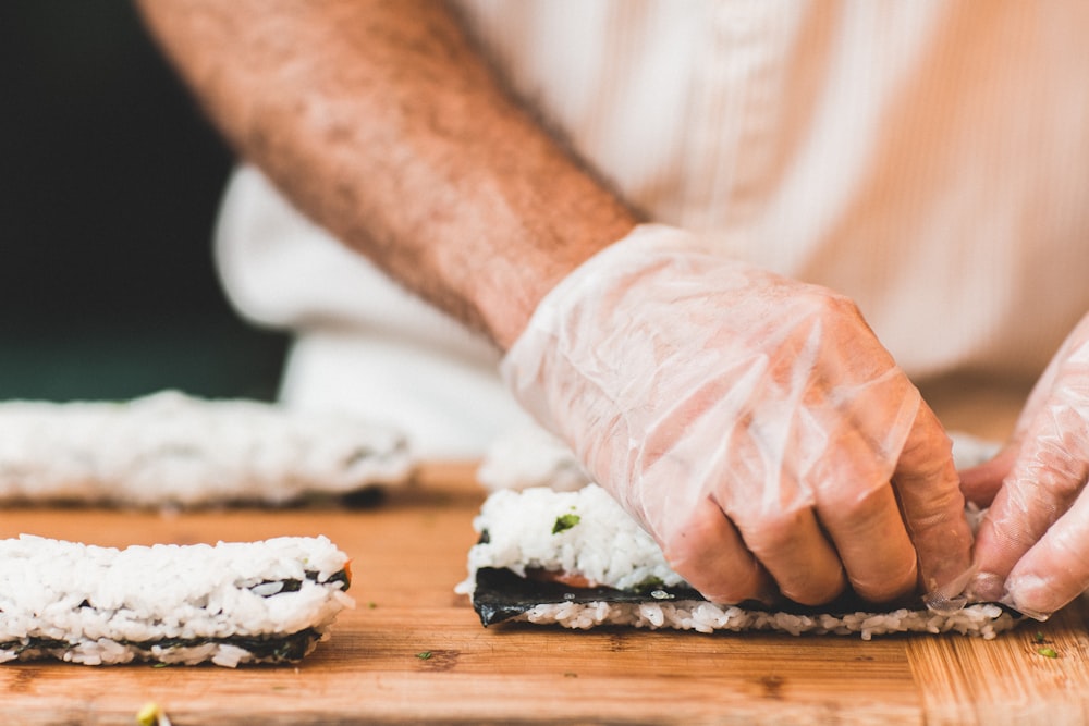 person making sushi