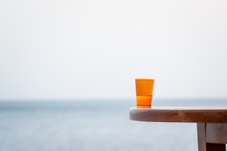 A serene coastal scene with soft sunlight illuminating handcrafted sea-inspired decor on a weathered wooden table.