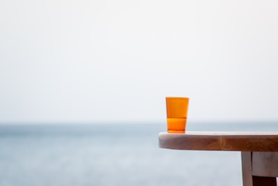 A serene coastal scene with soft sunlight illuminating handcrafted sea-inspired decor on a weathered wooden table.