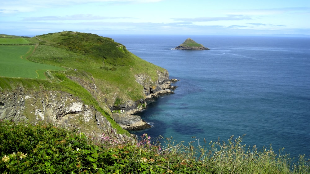 cliff near seashore at daytime