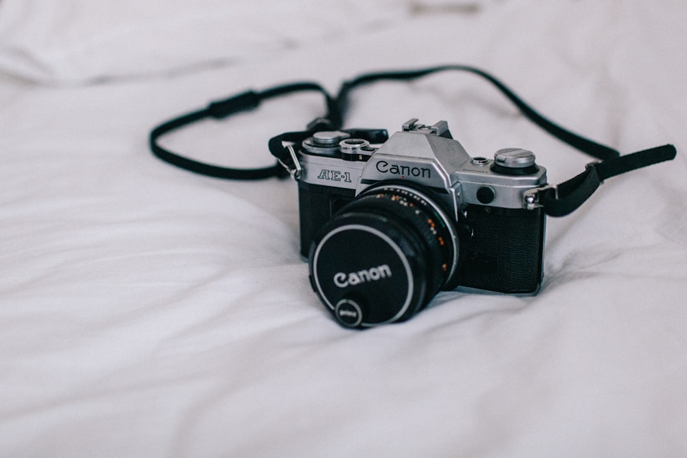 black and silver Canon DSLR camera