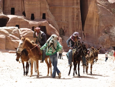 Tourists riding donkeys and camels through the scenic countryside near Akermoud.