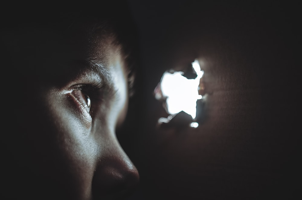 person watching through hole