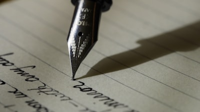 fountain pen on black lined paper