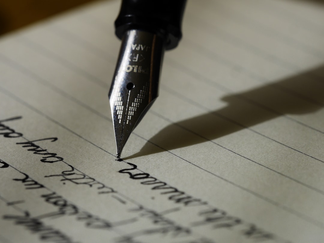 Close-up of a fountain pen writing in a notebook